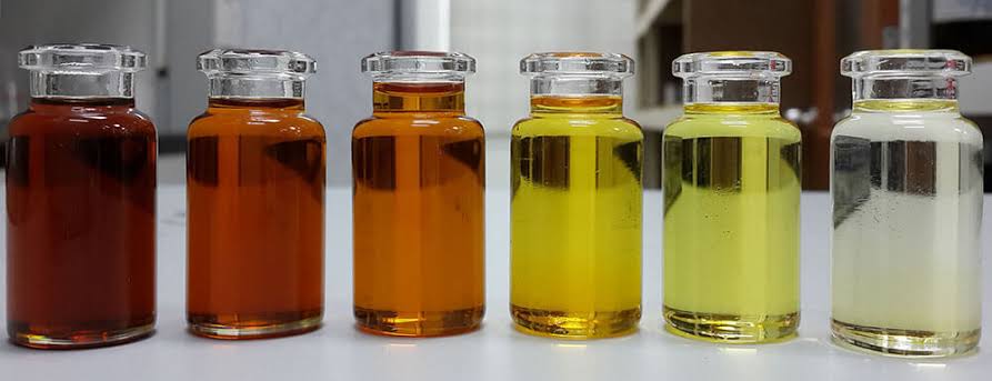 Sample vials of lubricant additives in a range of colours